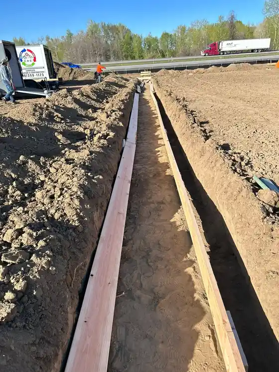 A long footing trench with timber forms.